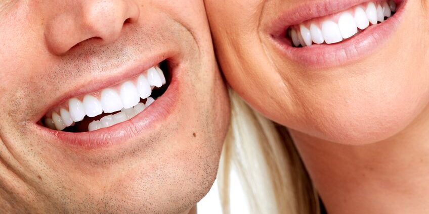 Beautiful woman and man smile. Dental health background.